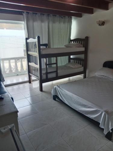 a bedroom with two bunk beds and a window at Habitaciones en Familia in San Andrés