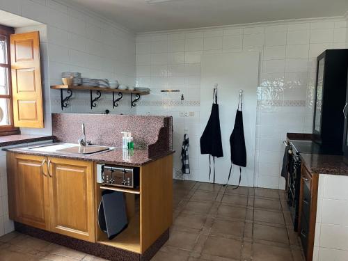 a kitchen with a sink and a counter top at Los Cuetos in Santianes