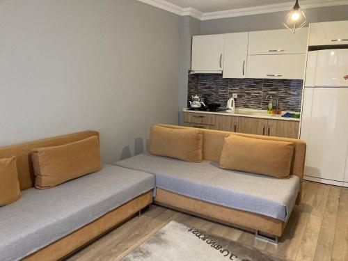 a living room with a couch and a kitchen at Rüya apart in Trabzon