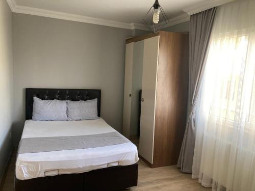 a bedroom with a large bed and a window at Rüya apart in Trabzon