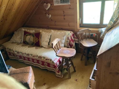 ein Wohnzimmer mit einem Sofa und 2 Stühlen in der Unterkunft Chalet en bois à la Foux d'Allos in Allos