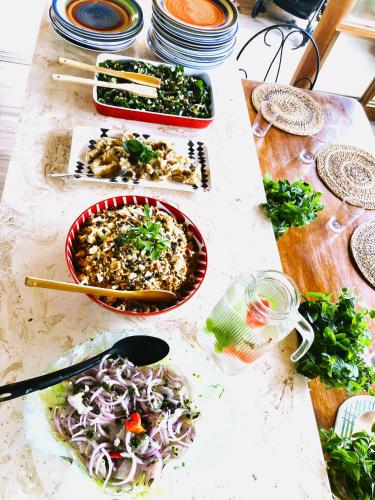 a table topped with bowls of food on top at AguaMar Vichayito in Los Órganos