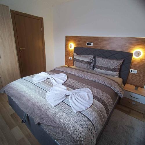a bedroom with a bed with bows on it at Vila Jasmina in Kolašin
