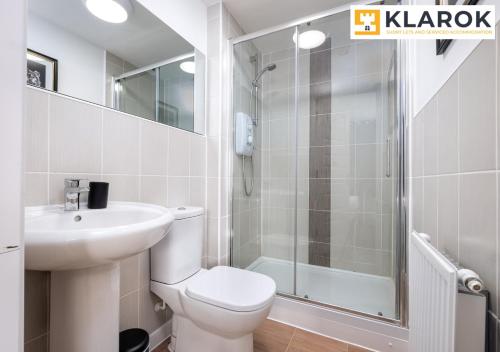 a bathroom with a toilet and a sink and a shower at Four Bedroom Semi Detached House By Klarok Accommodation Peterborough With Free Parking & Garden in Peterborough
