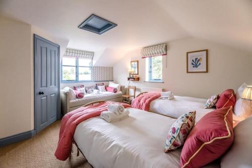 a bedroom with two beds and a living room at The Old Forge, Great Glemham in Great Glemham