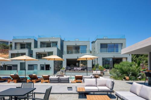 a large building with tables and chairs and umbrellas at Isla Villas & Suites in Balíon