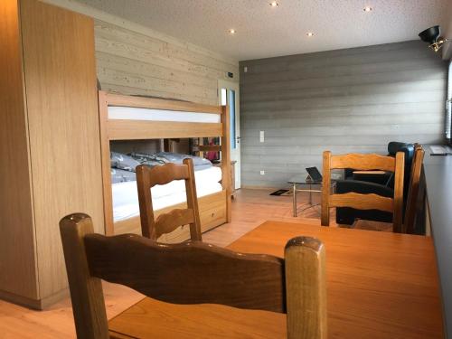 a dining room with a table and a bunk bed at POSTRELAIS ARDENNES "Belvedere" in Burg-Reuland