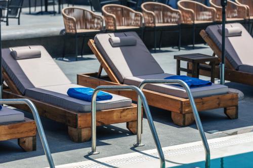a row of beds sitting next to a pool at Isla Villas & Suites in Balíon
