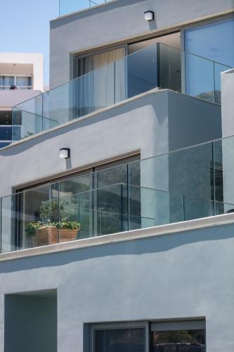 an external view of a building with glass windows at Isla Villas & Suites in Balíon
