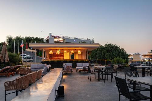 a patio with tables and chairs and a restaurant at Isla Villas & Suites in Balíon
