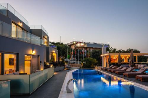 a hotel with a swimming pool with lounge chairs at Isla Villas & Suites in Balíon