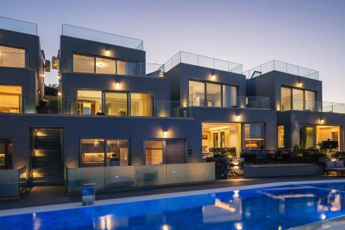 a house with a swimming pool in front of it at Isla Villas & Suites in Balíon