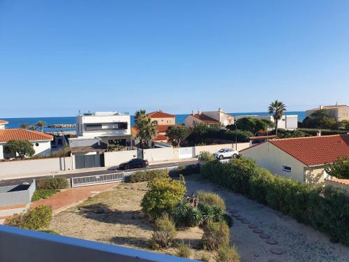 arial view of a city with houses and a street at La plage du Lido in Le Barcarès