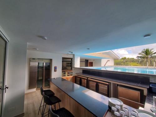 a kitchen with a swimming pool in the background at Lakaz Kreol in Beau Vallon