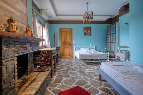 a room with a fireplace and a bed and a bedroom at Stefania's Houses in Zagora