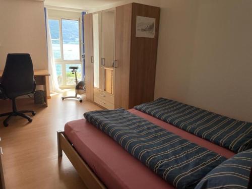 מיטה או מיטות בחדר ב-Ferienwohnungen mit 4 Betten in Gersau direkt am Vierwaldstättersee