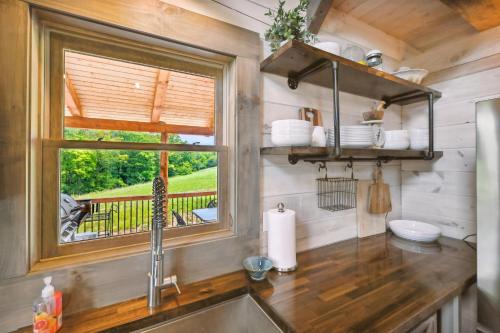 eine Küche mit einem Waschbecken und einem Fenster in der Unterkunft Modern Willis Cabin Retreat 24-Acre Working Farm! in Willis