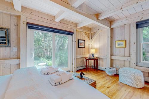 a bedroom with a large bed and a large window at Tranquil Haven in West Tisbury