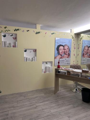 a room with a desk and posters on the wall at Garni Villa Betty in Merano