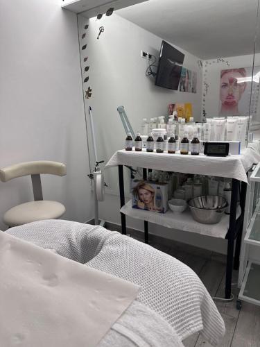 a room with a table with a lot of cosmetics at Garni Villa Betty in Merano