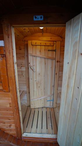 a wooden sauna with a door in the middle at Kazbegi Spa Resort Cottages in Stepantsminda