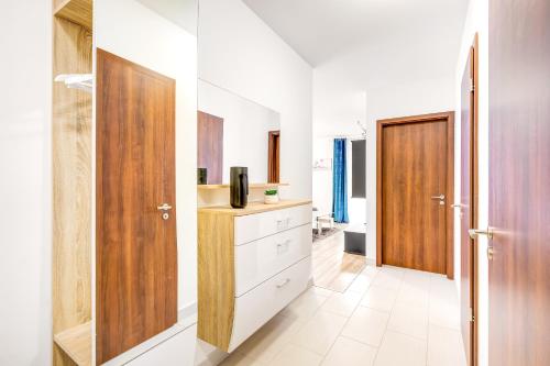 a kitchen with white walls and a wooden door at Modern apartment with free garage and balcony in the downtown in Budapest
