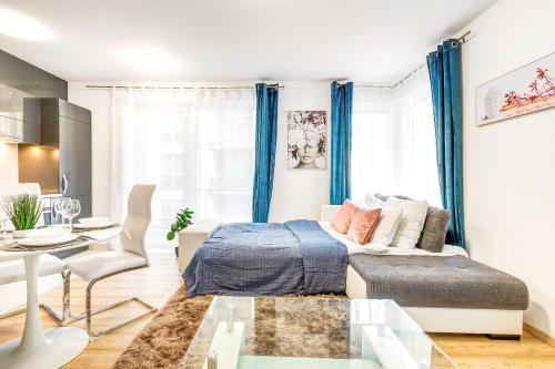 a bedroom with a bed and a dining room at Modern apartment with free garage and balcony in the downtown in Budapest