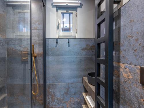 a bathroom with a shower with a glass door at Appartement skis aux pieds avec parking et wifi au cœur de Val-d’Isère - FR-1-694-317 in Val dʼIsère