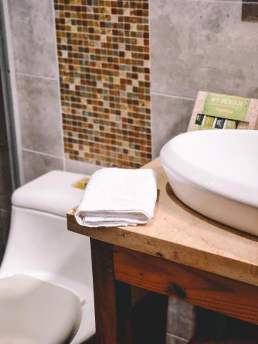 a bathroom with a sink and a toilet at Hotel Radoa in El Banco