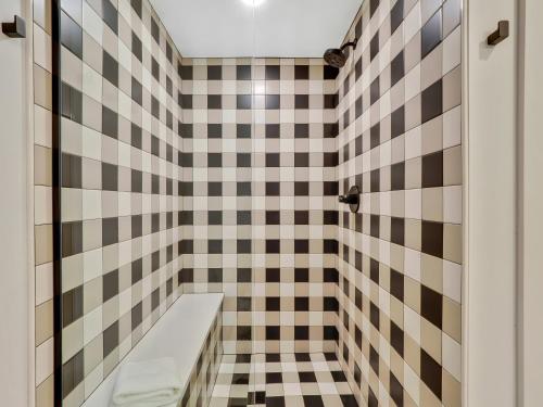 a bathroom with black and white checkered tiles at Rustic Meadows in Boyne Falls