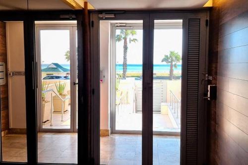 an open door with a view of the beach at 16 Serenity Studio - Dolphin Bay in Cape Town