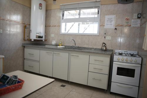 a kitchen with a sink and a stove at MAR & ARENA in Puerto Madryn