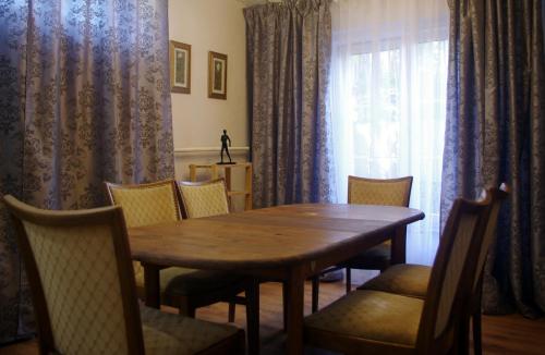 a dining room table with chairs and a window at Villand Hotel with Free Private Parking and Self Check In in Rīga