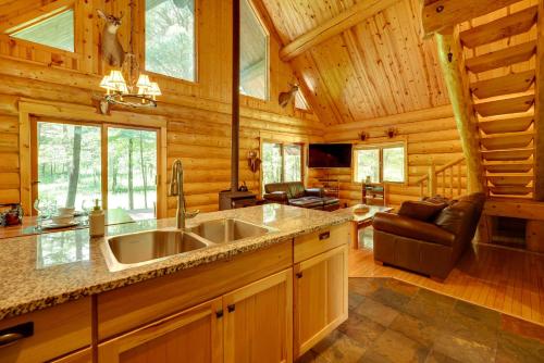 a kitchen with a large sink in a log cabin at Secluded Log Cabin in NW Michigan Hot Tub and Deck in Evart