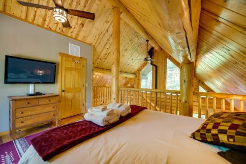 1 dormitorio con 1 cama grande en una cabaña en Secluded Log Cabin in NW Michigan Fire Pit and Deck, en Evart