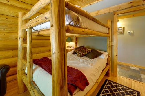a bedroom with two bunk beds in a cabin at Secluded Log Cabin in NW Michigan Hot Tub and Deck in Evart