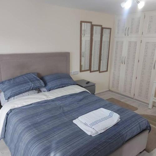 a bedroom with a bed with two towels on it at Lovely & Beautiful 2 Bed-Apartment in Borehamwood in Borehamwood