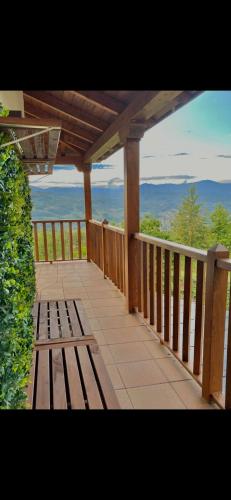 a wooden deck with a bench on a balcony at Casa El Santanderino in El Espino