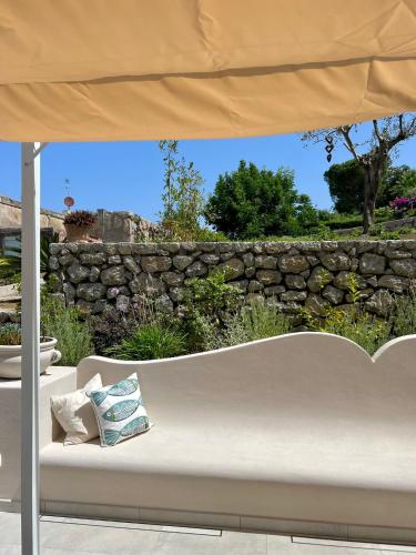a white couch under an umbrella on a patio at Amamì B&B in Anacapri