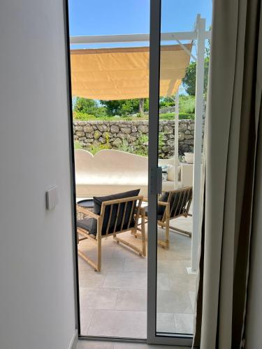 a sliding glass door to a patio with a table and chairs at Amamì B&B in Anacapri