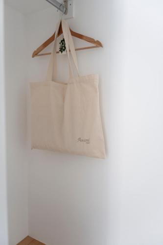 a white tote bag hanging on a wall at Amamì B&B in Anacapri