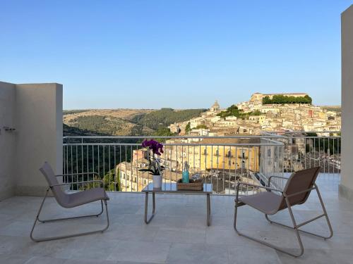 a balcony with a table and chairs and a view at La casa di Irene - Suites con vista in Ragusa