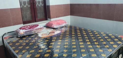 a bed in a room with plastic bags on it at Hallima Service Apartments Non Ac Homestay low Budget in Pudukkottai