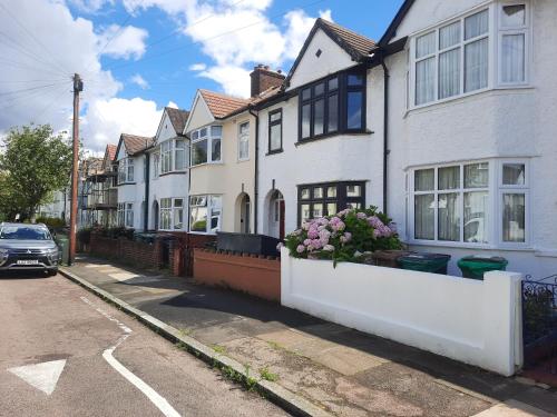 a row of white houses on a street at Alross studio flat / private bathroom in London