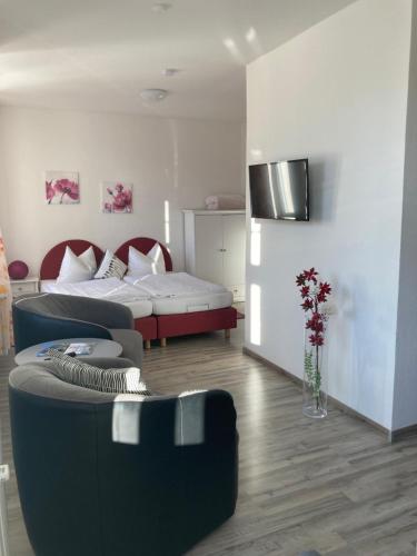 a living room with a couch and a bed at Haus Brandenburg in Stechlin