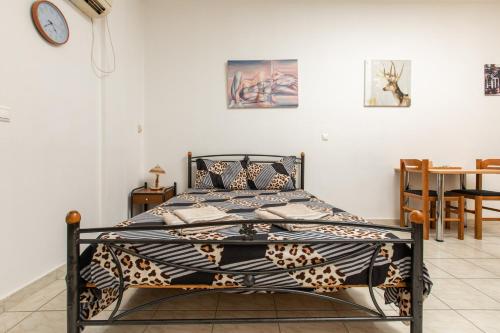 łóżko w pokoju z zegarem na ścianie w obiekcie Central Cozy Apartment w mieście Sparta