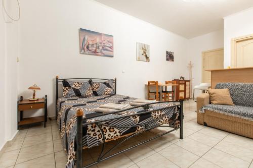 a bedroom with a bed and a couch at Central Cozy Apartment in Sparta