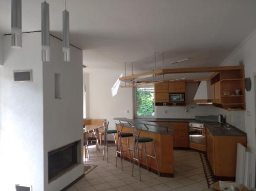 a kitchen with wooden cabinets and a table and chairs at u koupaliste in Mimoň