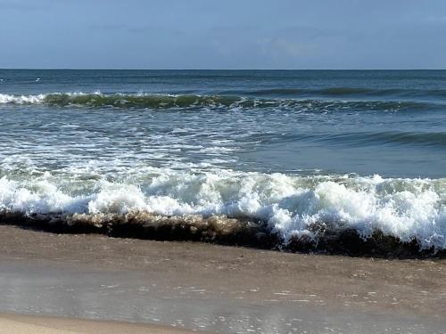 a group of waves in the ocean on a beach at Apartament Przy Plaży in Władysławowo