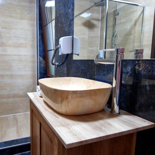 a bathroom with a large bowl sink on a counter at Provence Suceava in Suceava